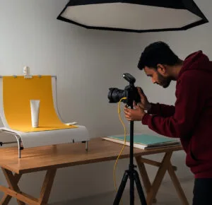 Photographer capturing product images in a professional studio setup.
