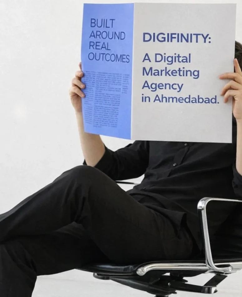 Person holding a magazine highlighting Digifinity as a digital marketing agency in Ahmedabad.