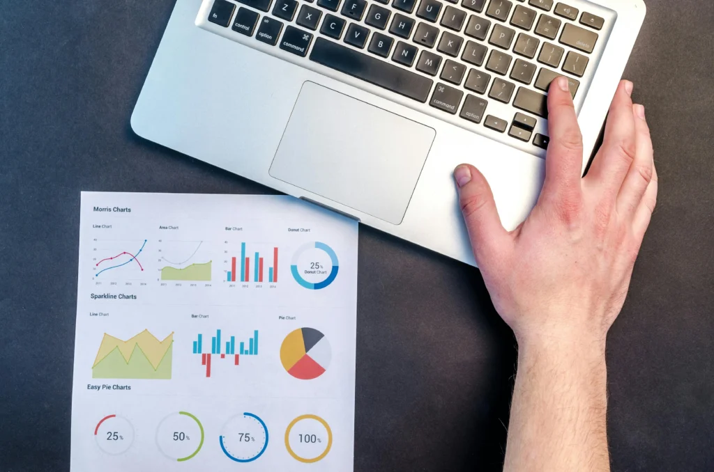 Marketing analyst reviewing data charts and performance metrics report 